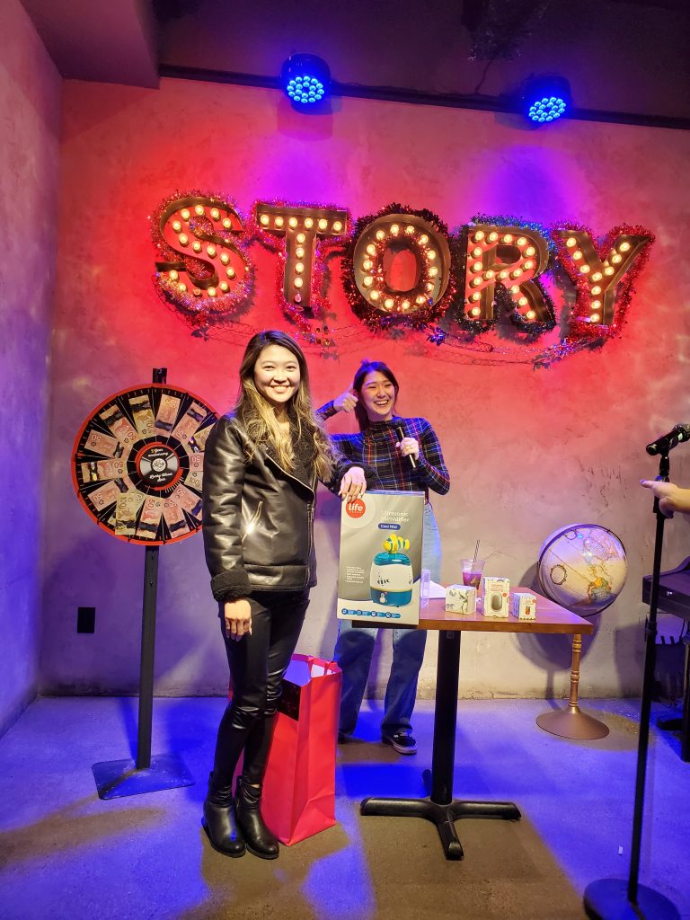 A prize winner under the STORY marquee sign