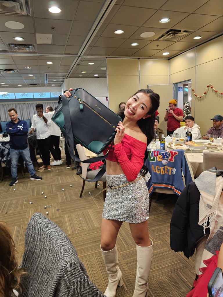 A team member showing off a new bag from the gift exchange