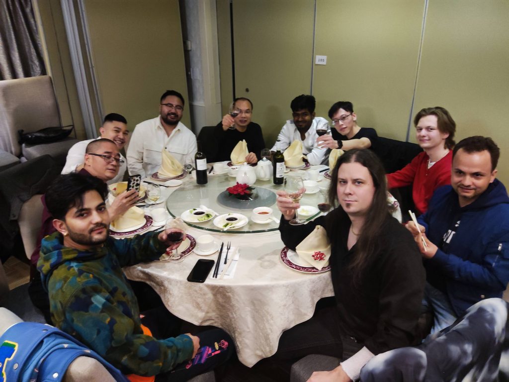 Team members raising their glasses around a banquet table