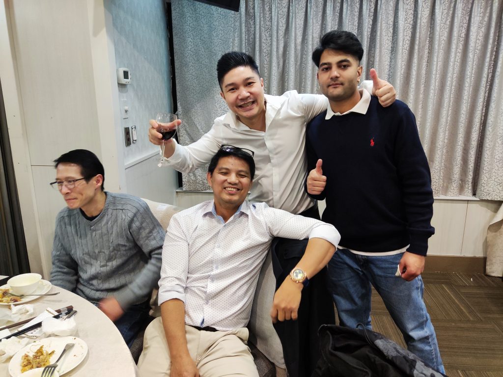 Team members raising a glass together at the 2024 Christmas party