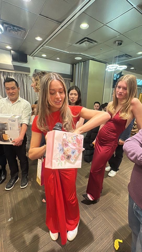 A team member opening her gift-exchange prize