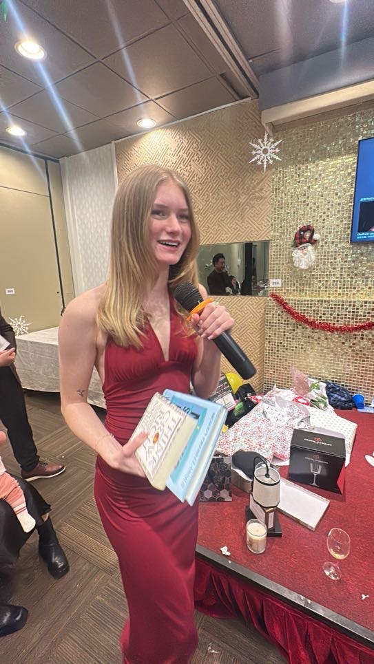 A team member showing her gift-exchange prize